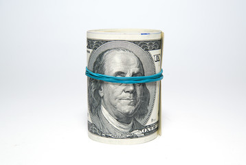 Bundle of US dollars banknotes on over white