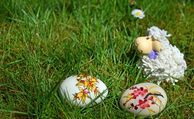 Easter Eggs with little sheep on a green grass