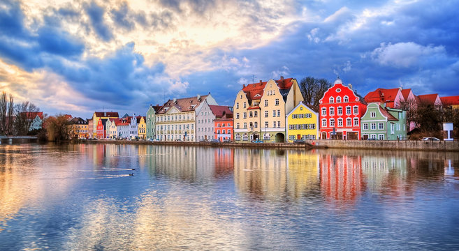 Colorful gothic houses reflecting in Isar river on sunset, Landshut, Germany