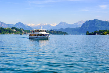 Fototapeta na wymiar Cruise ship in front of Alps mountains peaks on Lake Lucerne, Switzerland
