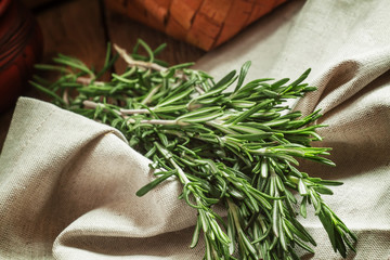 Fresh spicy fragrant rosemary on a gray napkin in rustic style,