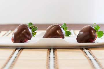 Strawberries with chocolate on table mat for Valentine's day or other love related situation