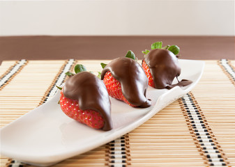 Strawberries with chocolate on table mat for Valentine's day or other love related situation