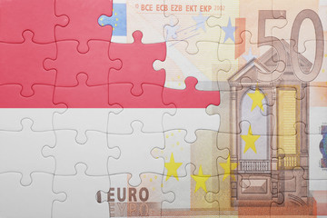 puzzle with the national flag of indonesia and euro banknote