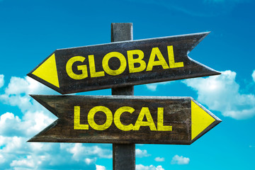 Global - Local signpost with sky background