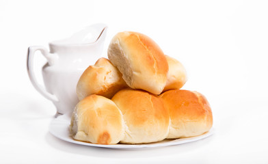 House pastries: pies on a white plate near a white jug