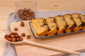 Homemade banana cake with hazelnuts on linen napkin