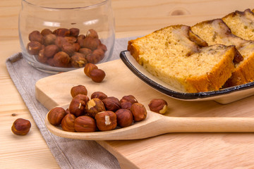 Homemade banana cake, wooden spoon with hazelnut