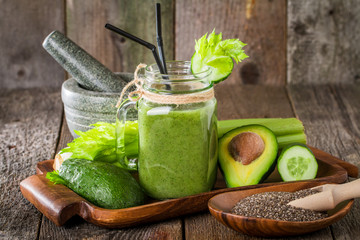 Healthy green juice smoothie with straw