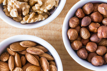 Three bowls of assorted nuts