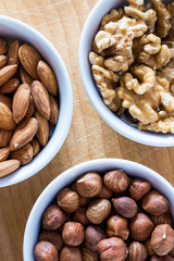 Three bowls of assorted nuts