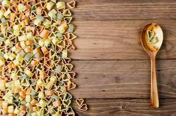 Pasta hearts on wooden background. Valentine's day background