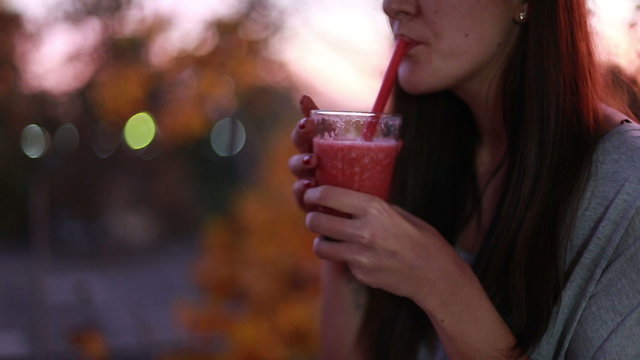 Young Woman Drinking Fruit Smoothie