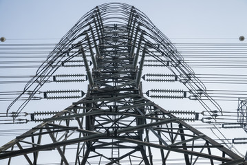 High voltage post electric power transmission tower and the blue sky background