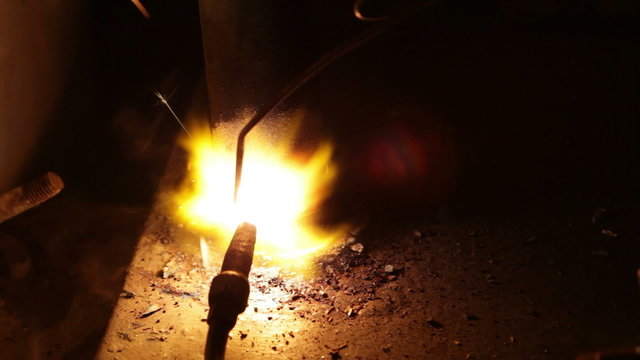 Close up process of welding metals in darkness