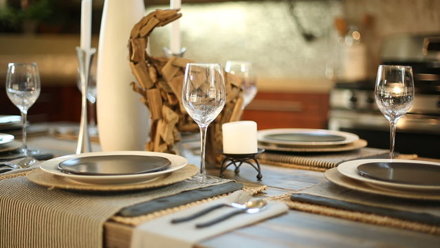 Dining Room Table Set for Dinner Close Up. camera slowly moves left on a set dining room table for dinner. Close up of modern design.
