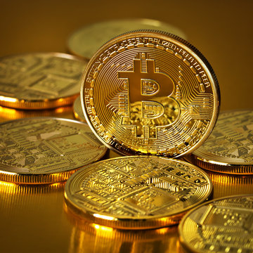 Golden Bitcoins on a gold background .Photo (new virtual money )
