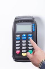 Male hand pressing menu button on a credit card machine