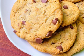 Traditional Chocolate Chip Cookies. Stack of chocolate chip cookies on a white plate.