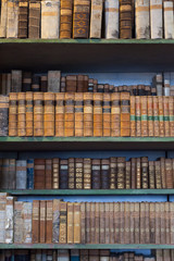 historic old books in library, wooden bookshelf