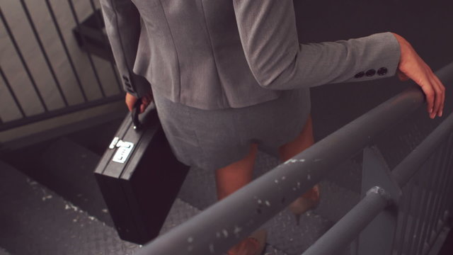 Businesswoman going down the stairs 