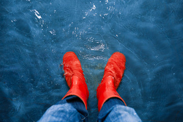red rubber boots in the water