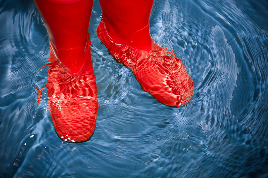 red rubber boots in the water