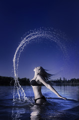 Attractive girl flipping hair in water