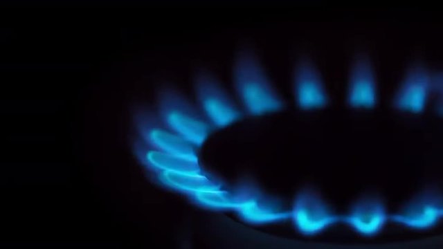 Gas Stove Burner Lighting Close Up Right. an extreme close up of a gas burner on a stove right justified. Audio included

