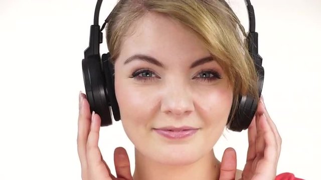 Woman in big headphones listening music closeup 4K