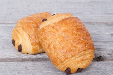 Two  French chocolatines on a wooden table