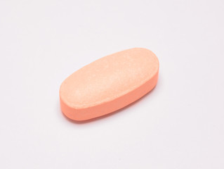 Orange pill on white