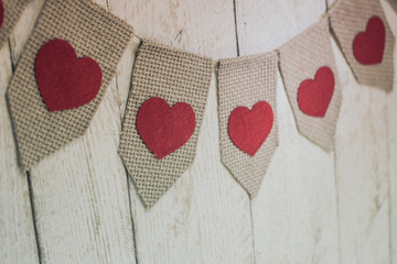 Fototapeta premium Valentine’s hearts on rustic wooden texture background 