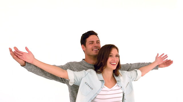 Happy couple with arms outstretched