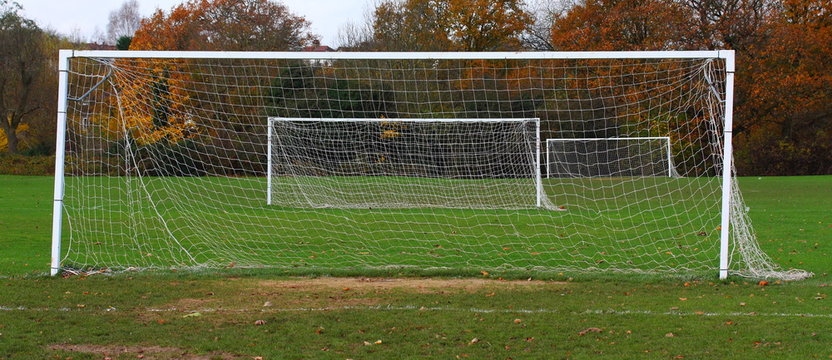 Panoramic image of football playground with three goalposts