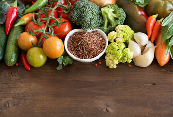 Uncooked Red rice in a bowl with vegetables