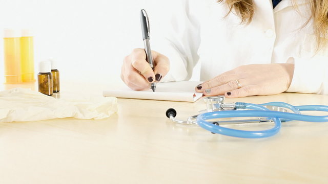 Doctor woman writing prescription.