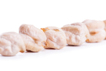 Align raw dry chickpeas on white background