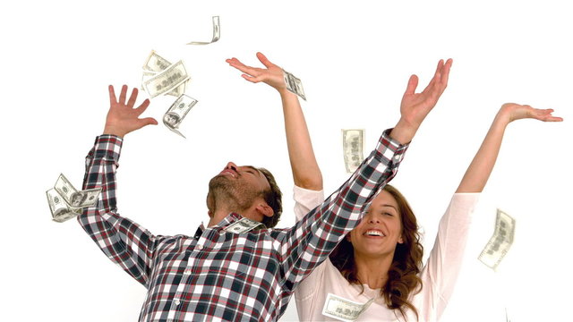 Happy couple throwing money