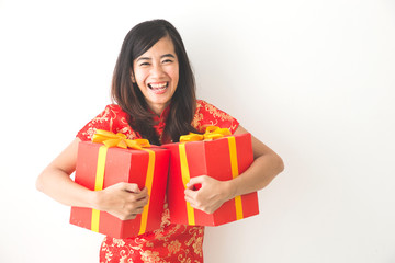 happy asian woman holding on gift box while celebrating chinese