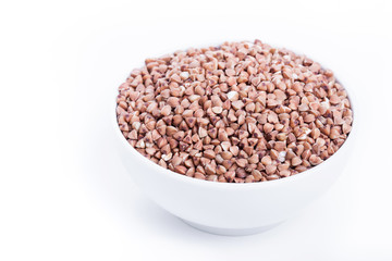 Dry buckwheat in white bowl