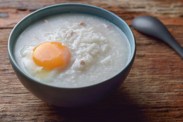Thai chinese asian rice porridge with pork and egg  in  bowl, co