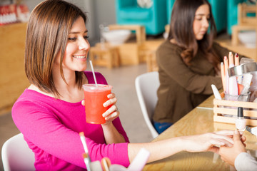 Cute woman relaxing in a nail salon