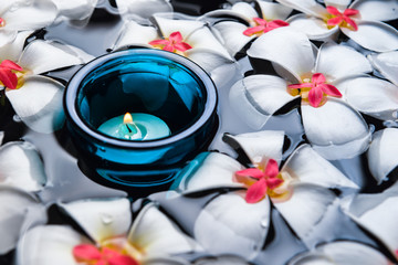 Candles  and beautiful flowers in the water spa