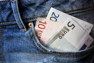 Euro banknotes in jeans pocket closeup