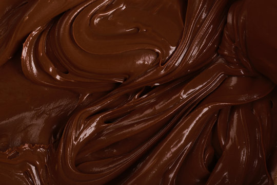 Background of thick melted milk chocolate, close-up