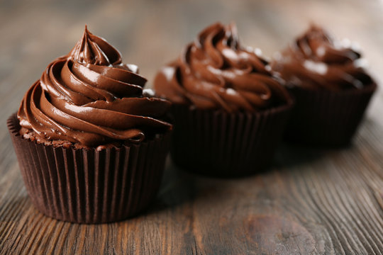 Chocolate cupcakes on dark wooden background