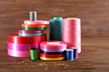 Spools of color ribbon on wooden background
