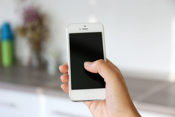Woman holding smartphone indoors