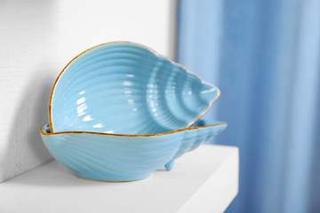 New blue dish on a shelf closeup